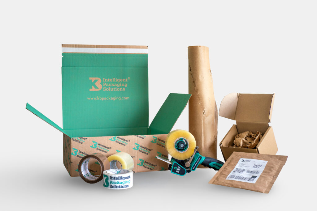 Packaging materials including a corrugated cardboard box, packaging tape, kraft paper, postal packaging, and void fill materials used for packing and shipping products.