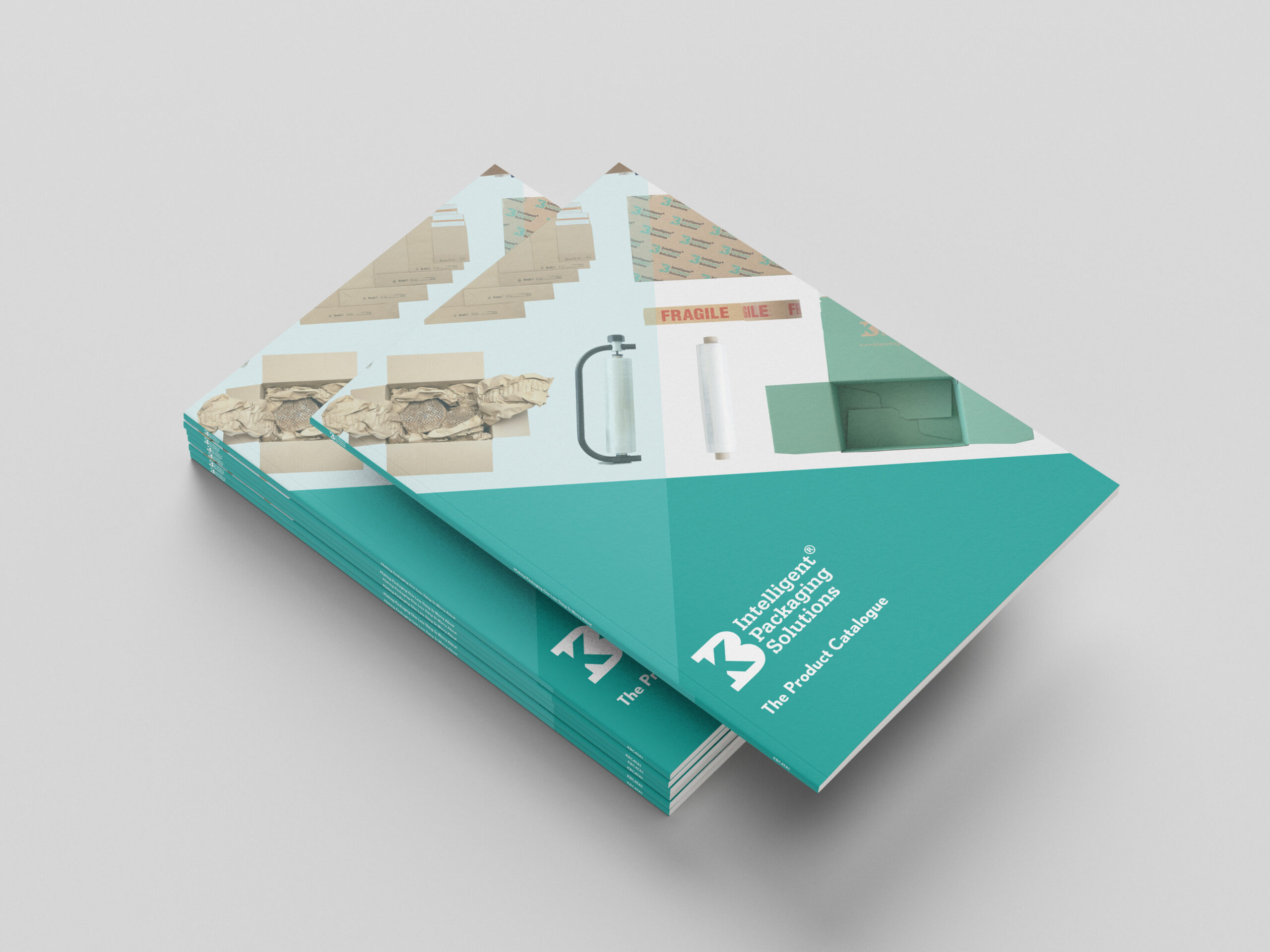Stack of KB Packaging product catalogues with a teal cover, featuring packaging products and protective packaging solutions displayed on the front cover in a realistic catalogue mock-up.
